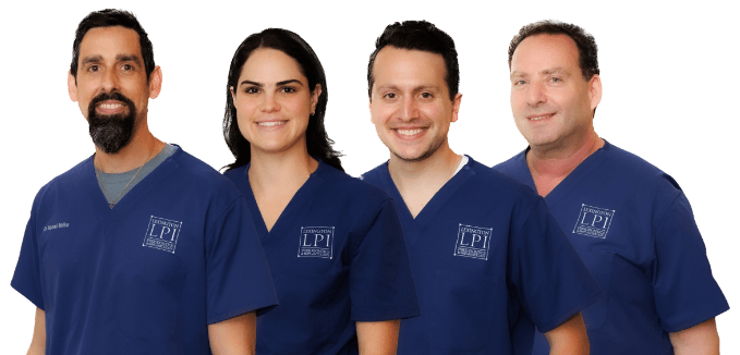 Four doctors from Lexington Periodontics and Implantology, starting from left-to-right of Doctor Manuel Molina (D.M.D., M.S., C.A.G.S.), Doctor Lauren Fitzgerald (D.M.D., M.S., C.A.G.S.), Doctor Elias Exarchos (D.M.D., C.A.G.S.), and Doctor Zori Rabinovtiz (D.M.D., M.S., C.A.G.S.).